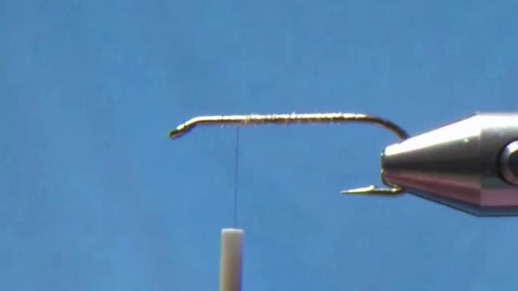 Fly hook coated with glue and covered in thread, ready for materials.