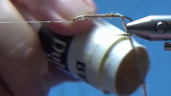 Pale brown polyyarn secured to the hook and dabbed with dubbing wax.