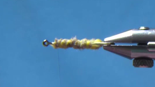 Fly body built up with polyyarn and golden olive dubbing, forming a slim silhouette.