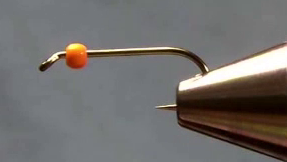Hook with orange bead slid on and barb crushed.