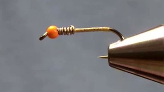 Hook shank covered with a smooth layer of tying thread.