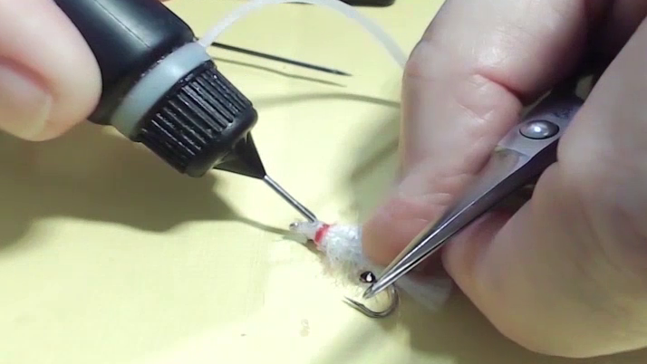 Small drops of UV resin applied to each side of the head to secure stick-on eyes in place.