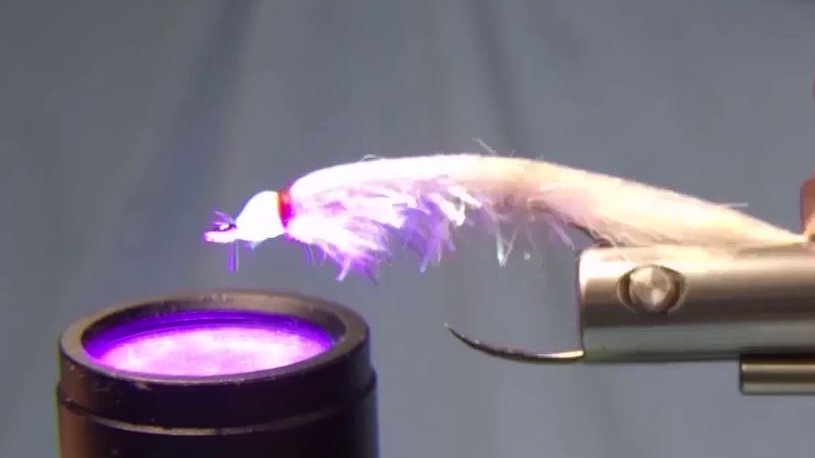 Light UV-resin coating applied over the thread head and cured with a UV torch to create a smooth base layer.