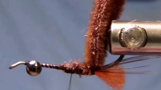 Fly after foam is tied in and folded up over the hook point, with the hook inverted and thread secured at the rear.