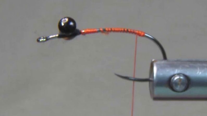 Hook with hourglass eyes secured in place and a smooth thread base covering the hook shank.