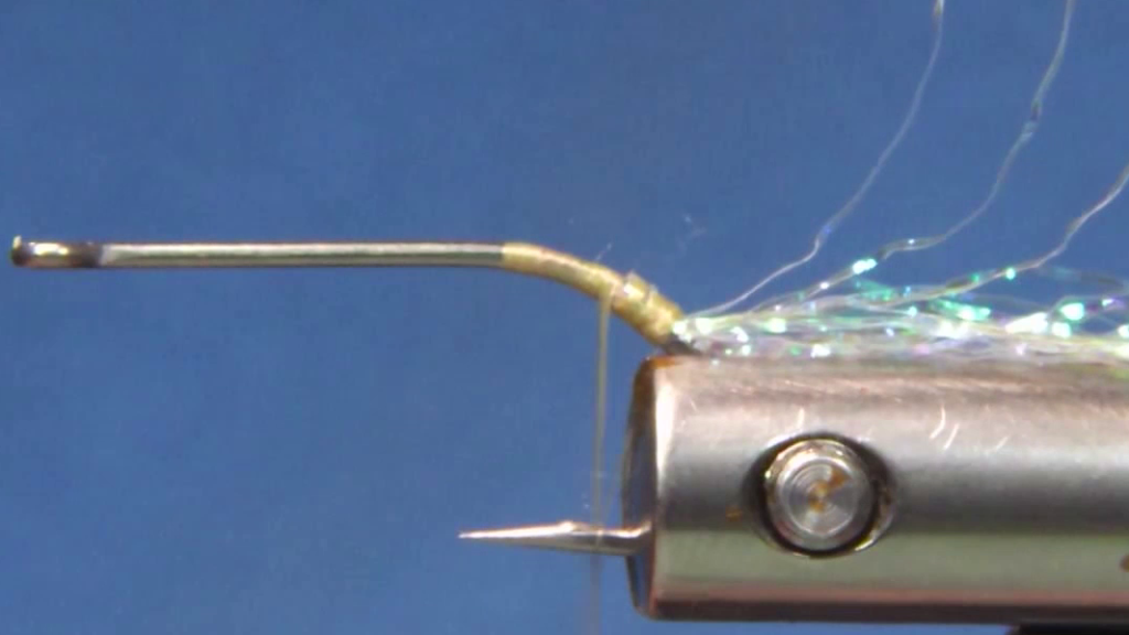 Hook secured in the vice with the hook barb crushed and a stripped pearl FF Braid tail tied in at the bend.