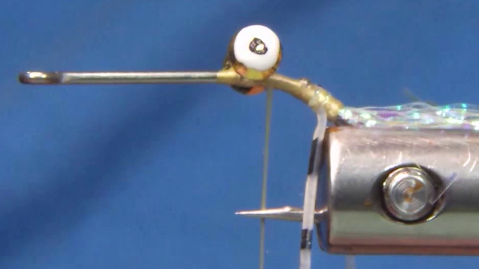 Clear black striped rubber legs tied along each side of the hook, with white dumbbell eyes securely figure-eight wrapped onto the hook shank.