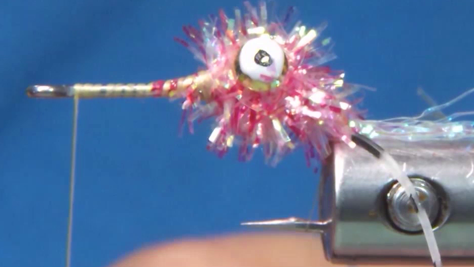 White sparkle chenille wrapped around the dumbbell eyes to form the head, with the hook rotated in the vice to the point-up position.
Image 4 (after Steps 7–8):