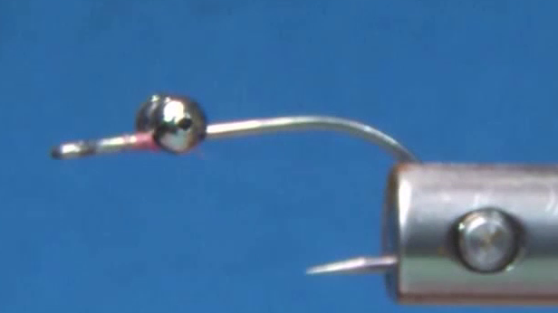 Bead chain eyes secured two eye lengths behind the hook eye, with the hook shank wrapped in pink thread back to the bend.
