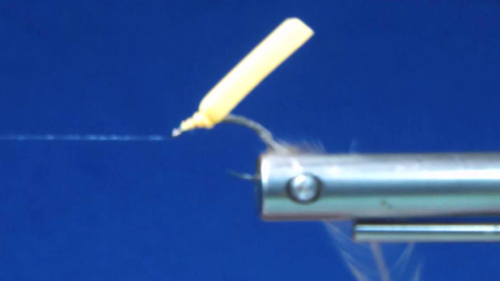 White saddle hackle tied in by the tips at the hook bend, with a yellow foam strip secured upright just behind the hook eye.