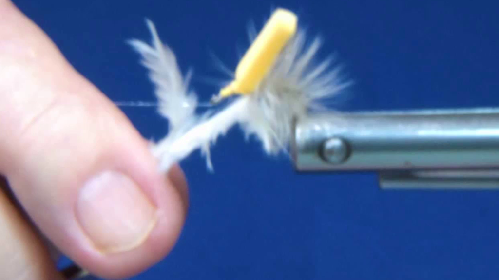 White saddle hackle wrapped in close, touching turns along the hook shank to the base of the upright yellow foam post.