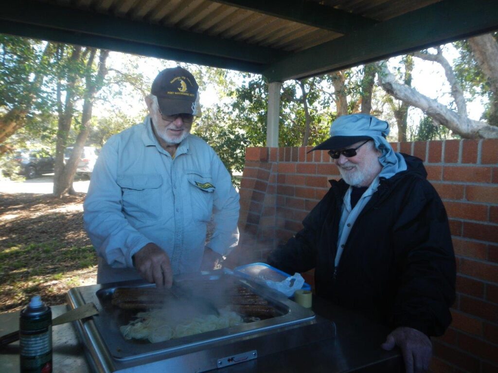 Don at the BBQ - Bob is pictured taking lessons from Don