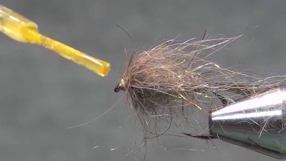 A small drop of Sally Hansen’s clear nail polish being applied to the thread head of the Hare’s Ear fly.