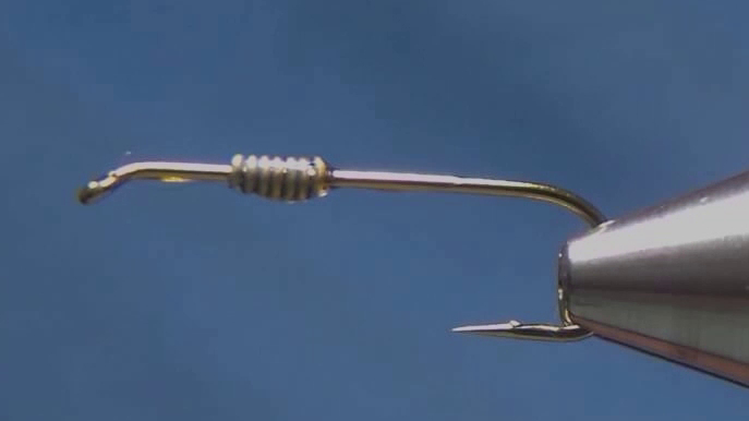 Hook prepared with barb crushed and lead-free wire wrapped around the shank.